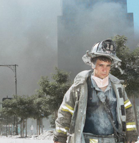 A firefighter walks away from Ground Zero after the collapse of the Twin Towers.