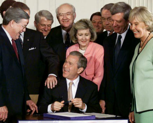 Congresswoman Dunn (r) at a 2001 White House ceremony at which President Bush signed into law a bill that lowered U.S. income taxes across the board.