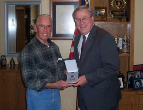 Presenting a Purple Heart to World War II Veteran and constituent Earle Massa