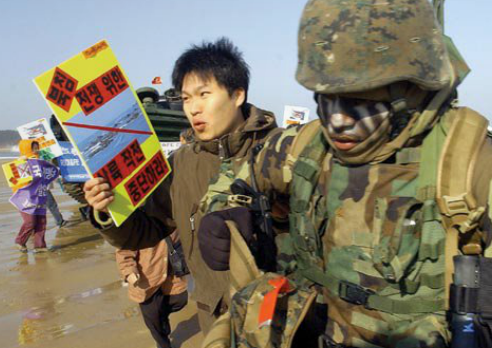 A protester pulls a U.S. marine in protest during a joint U.S.-South Korea military exercise at Mallipo beach, southwest of Seoul in March 2006.