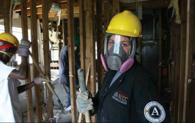 An AmirCorps member inside a house damaged by Hurricane Katrine in Louisiana