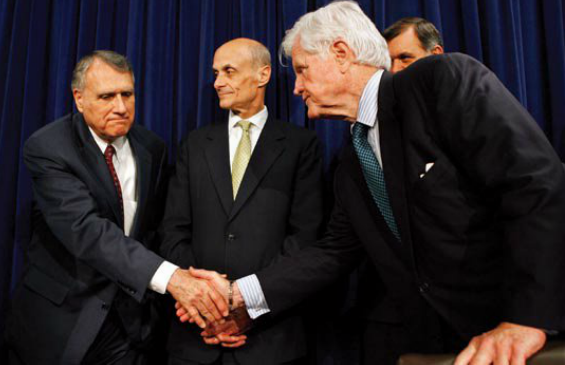 Republican Senator Jon Kyl and Democratic Senator Edward Kennedy, at a May 17 news conference announcing the bipartisan agreement on the immigration reform bill. Homeland Security Secretary Mitchael Chertoff and Senator Mel Martinez (R-FL) are in the back.